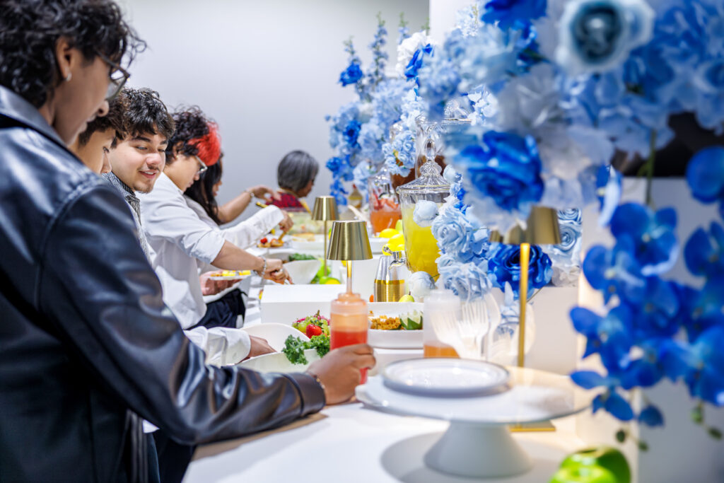 People enjoying a colorful buffet setup.