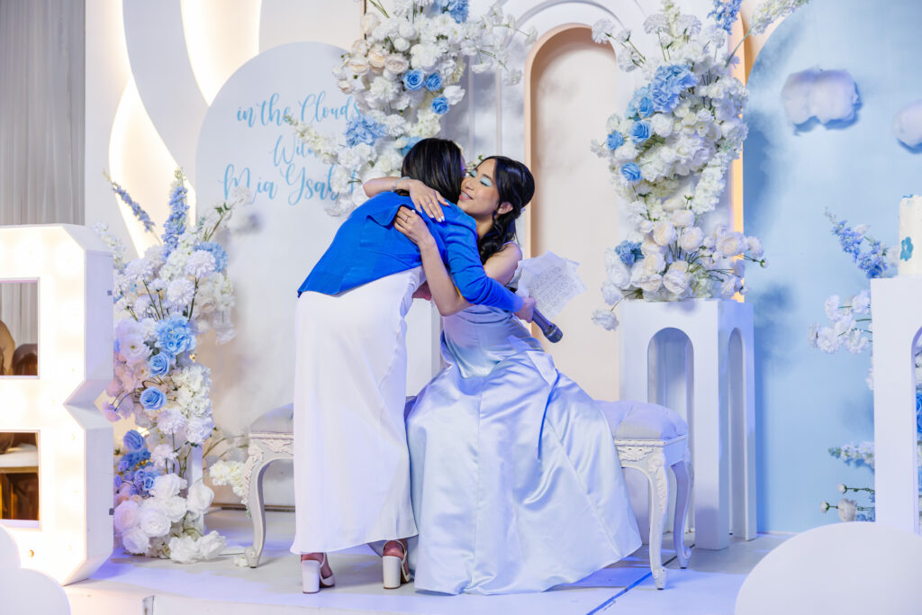 Two women embracing at celebration.