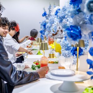 People enjoying a colorful buffet setup.